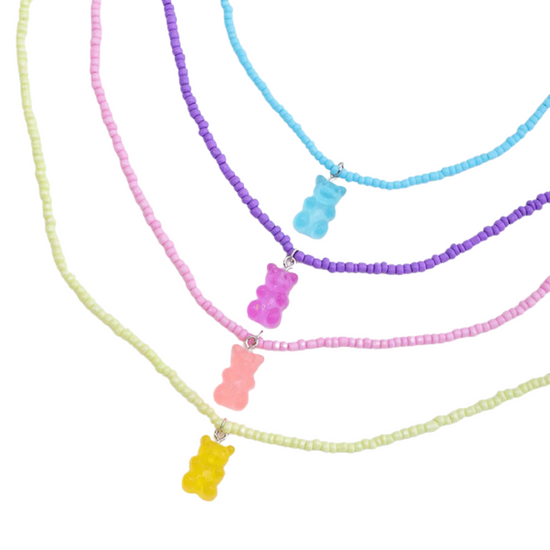 Treat yourself to an adorable set of four gummy bear necklaces! Hand-strung with blue, yellow, pink, and purple beads, these candied confections will have you looking sweet - and feeling sweeter! Perfect for the gummy bear lover in your life. Yum!