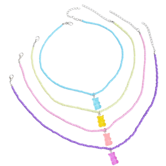 Treat yourself to an adorable set of four gummy bear necklaces! Hand-strung with blue, yellow, pink, and purple beads, these candied confections will have you looking sweet - and feeling sweeter! Perfect for the gummy bear lover in your life. Yum!