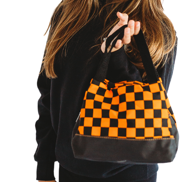 Our Checkered Halloween Bag is the perfect way to spook up your wardrobe this fall! With a classic vintage design in vibrant orange & black, it's sure to bring a little bit of frightful fun to any traditional get-up. Boo-yah!