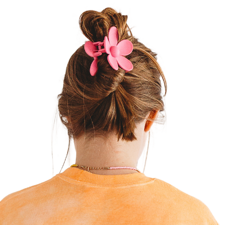 Make a statement with our Malibu Girl Hair Claw! This fun and flirty flower-shaped hair accessory is perfect for any occasion. Get ready to turn heads and have all eyes on you!