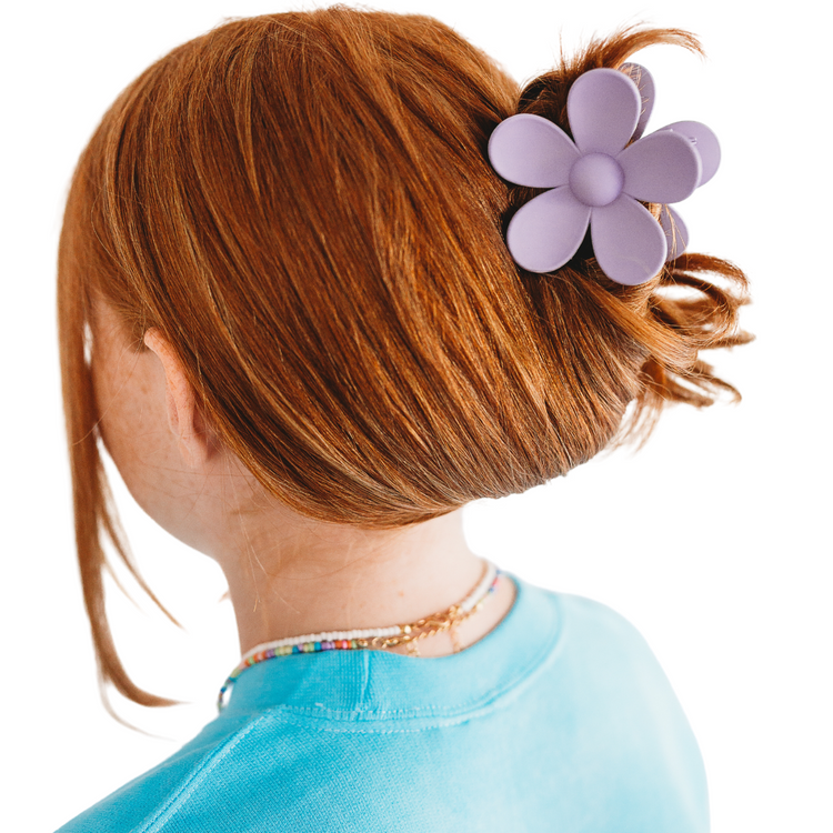 Make a statement with our Malibu Girl Hair Claw! This fun and flirty flower-shaped hair accessory is perfect for any occasion. Get ready to turn heads and have all eyes on you!